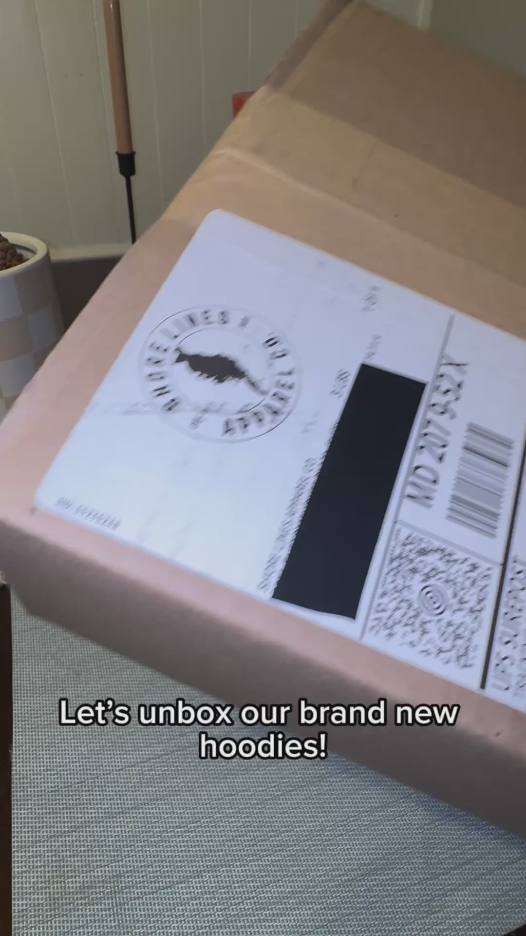 Load video: Unboxing two hoodies: charcoal and dusty rose colors.